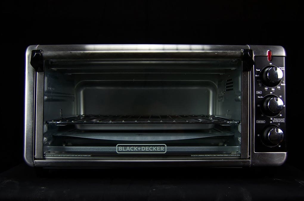 Microwaves sitting against a black background