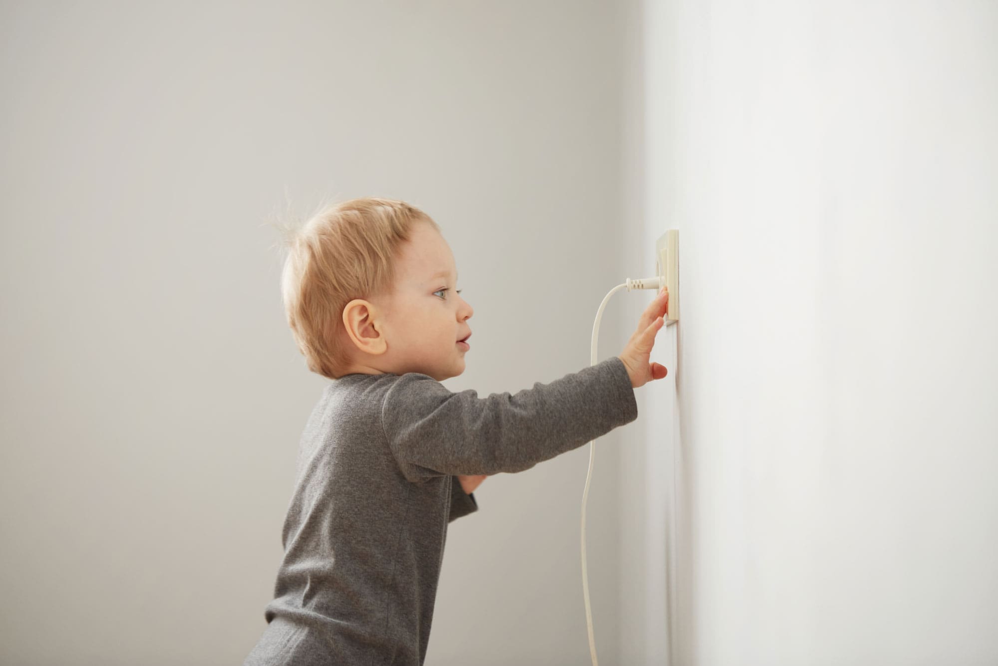 kid reaching for an electric socket