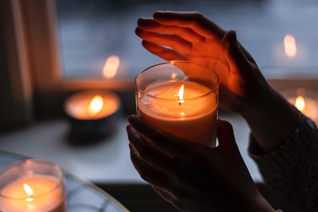 Picture of a boy holding a candle during a blackout