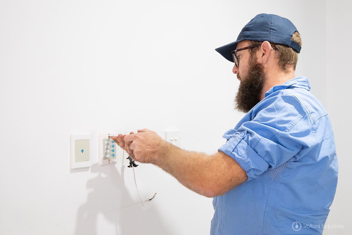 electrician applying smart technology to a home