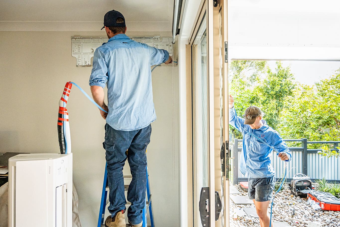 professionals fixing an air conditioner