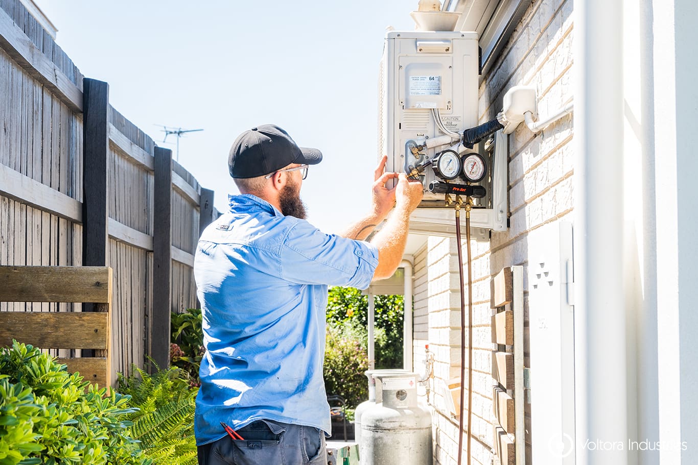 electrician checking the HVAC of an air conditioner