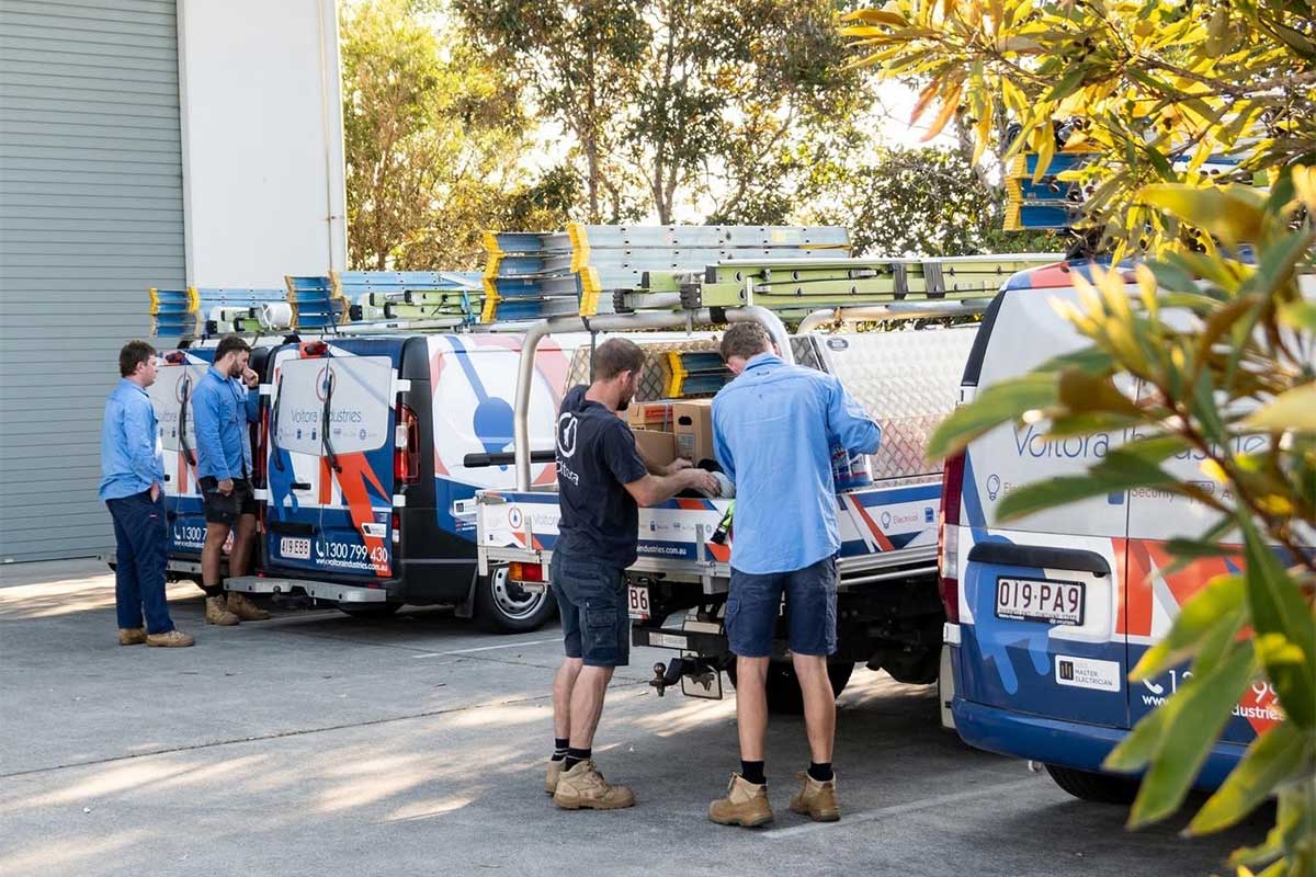 electricians preparing by their trucks